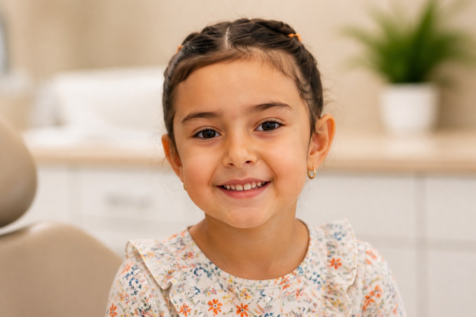 Smiling young girl sitting in a dental office