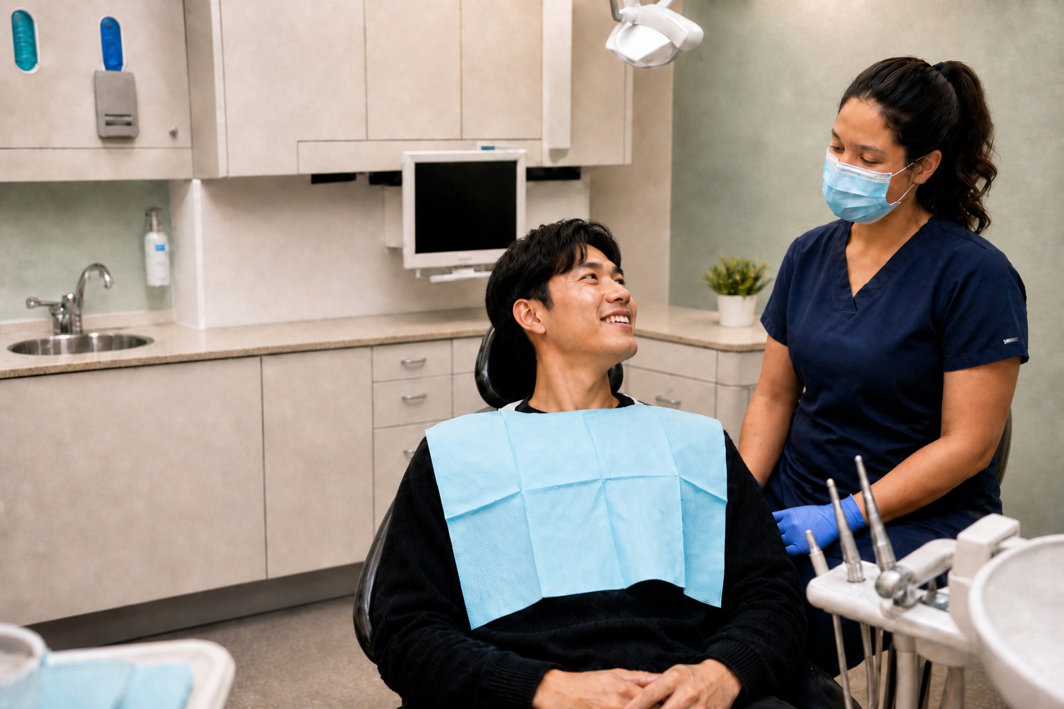 Patient talking with a dental assistant before treatment