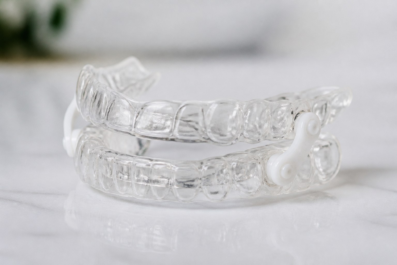 Custom oral appliance for snoring and sleep apnea on a marble surface